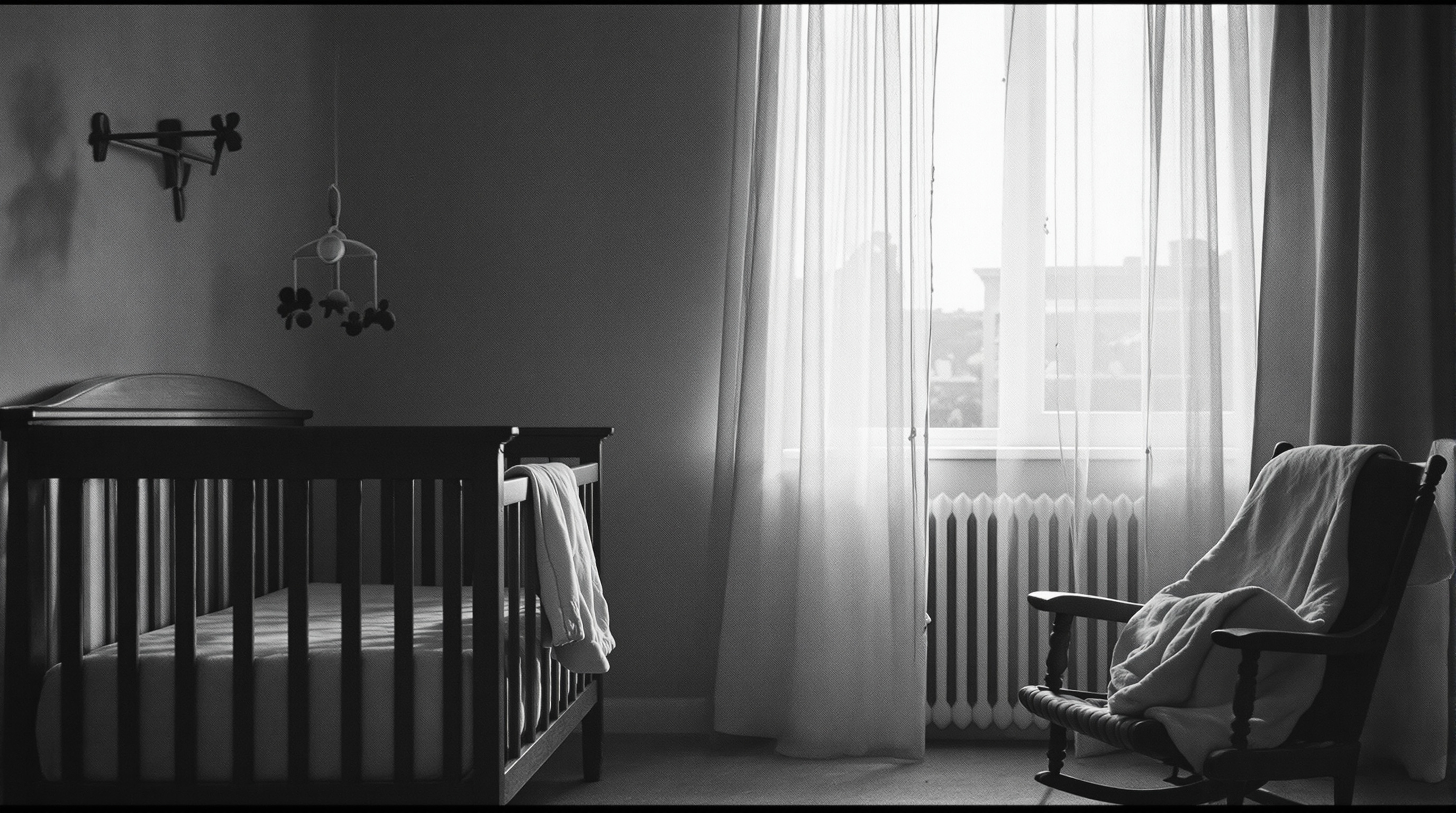 Empty nursery at dawn with crib, rocking chair and soft window light