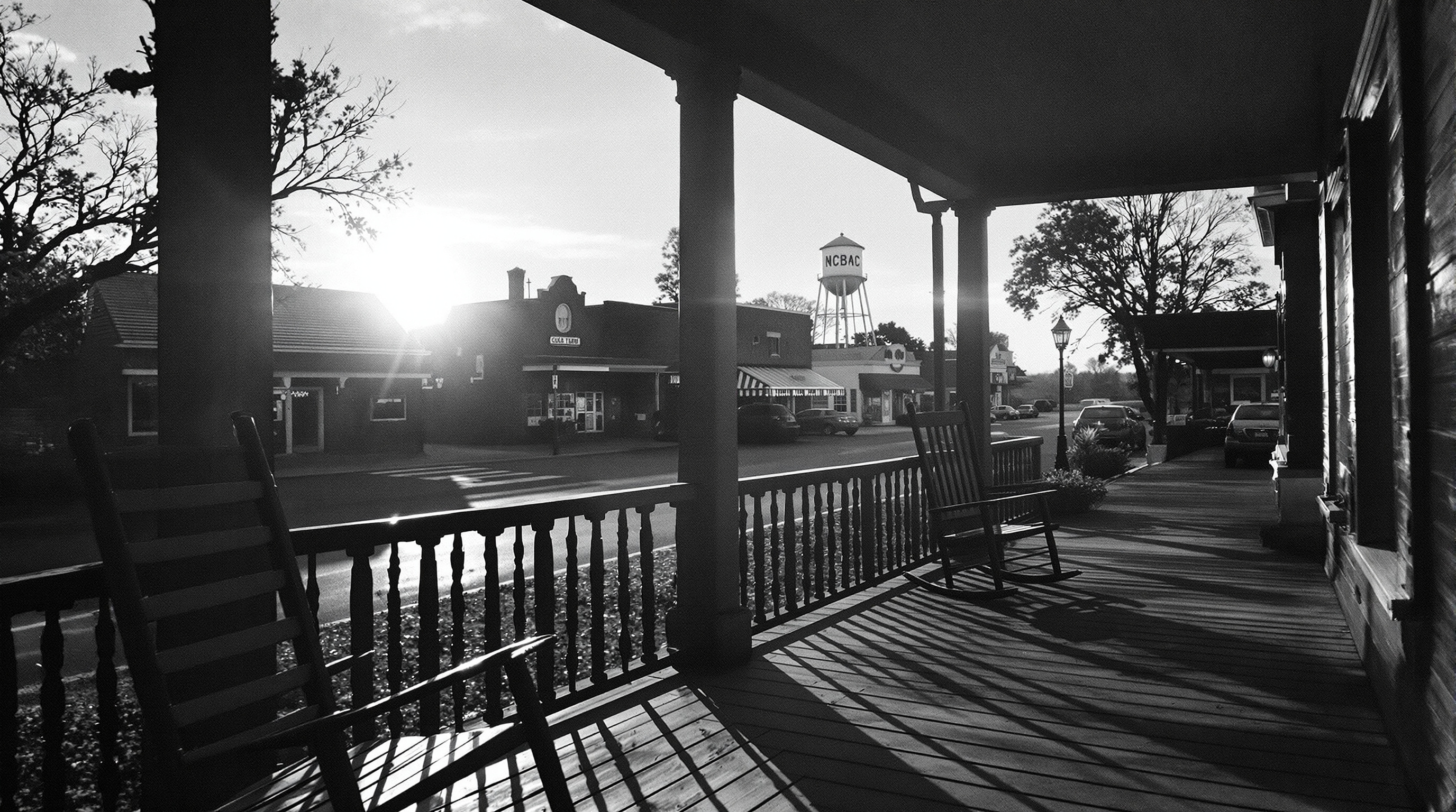 View of a small town main street from a wooden porch with rocking chairs
